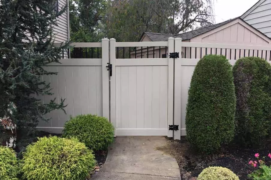 White vinyl gate and fence with black metal decorations