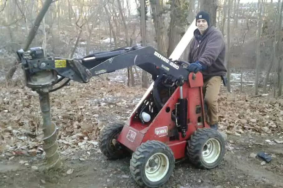 Man using Toro post digger in winter